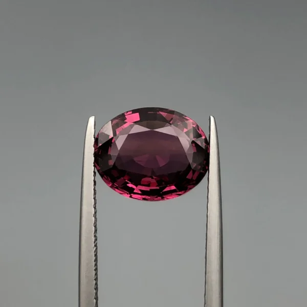 Natural Garnet 3.5ct A Natural garnet 3.5 carat purplish pink oval gemstone (front side)